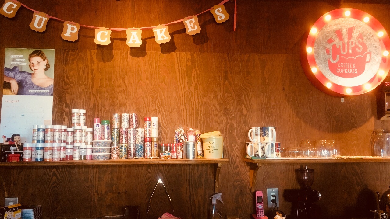 「CUPS　コーヒー＆カップケーキ」の店内壁面　レジ側
